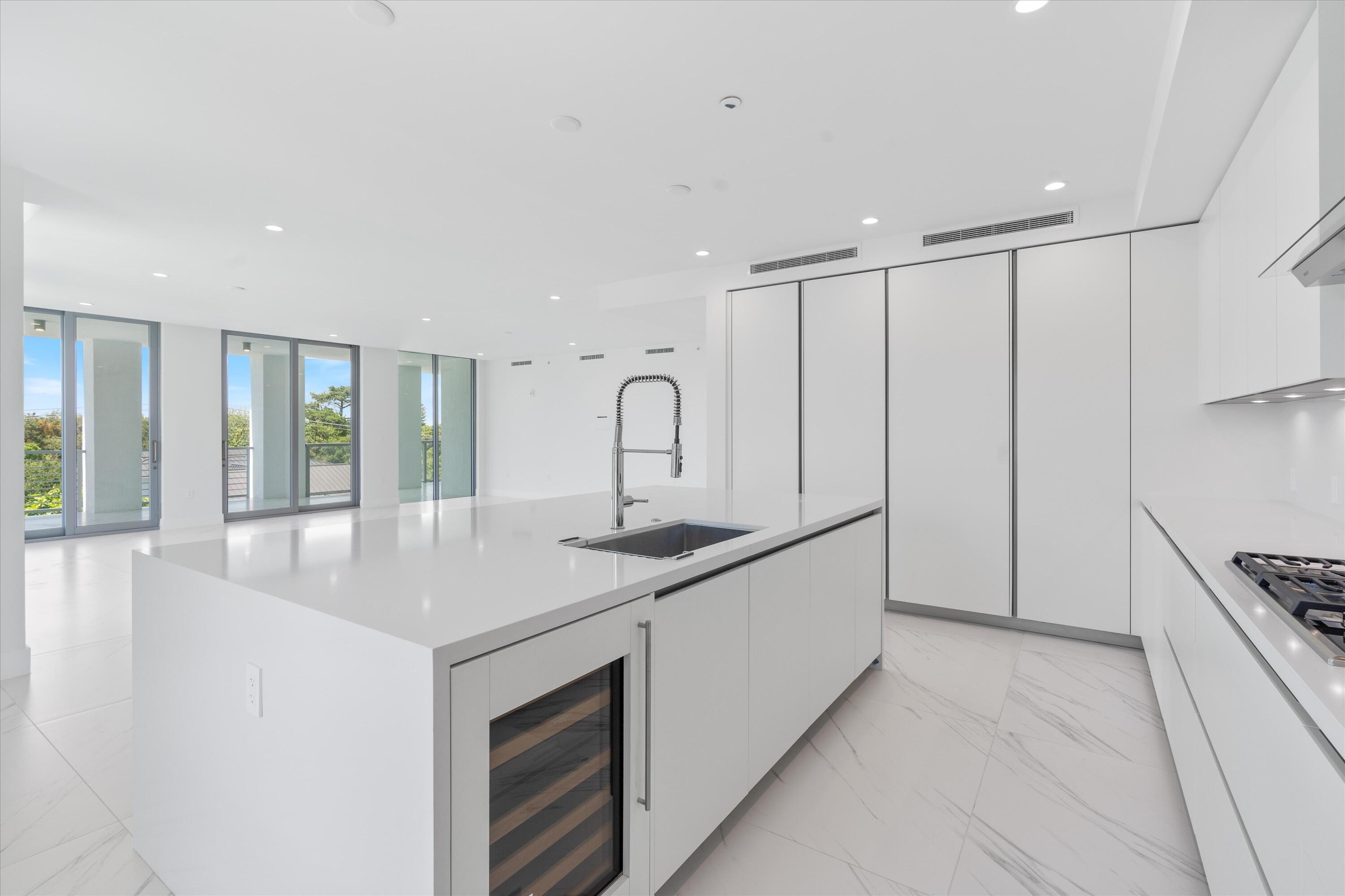 495 East Royal Palm Road, Unit 402 Boca Raton, FL 33432 - Photo 11 of 72 a kitchen with stainless steel appliances granite countertop a sink stove and cabinets