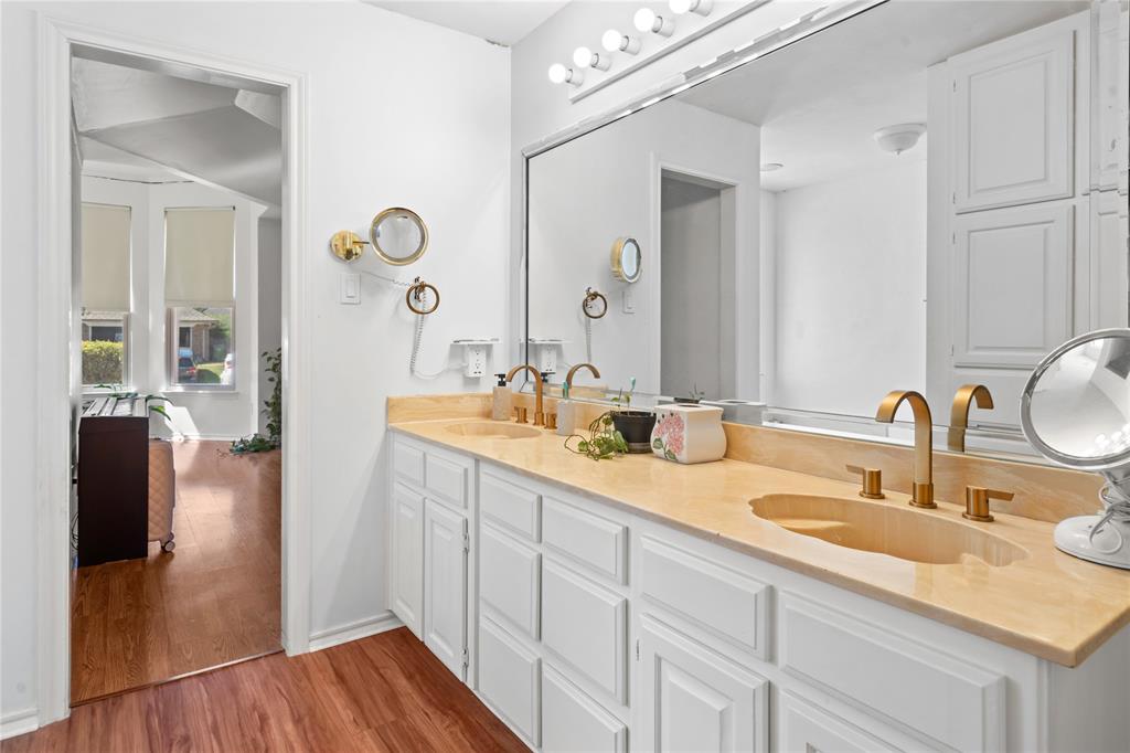 3506 Ruidoso Drive Arlington, TX 76017 - Photo 29 of 37 Double vanity featuring a light-toned countertop with integrated sinks and brass-finish hardware