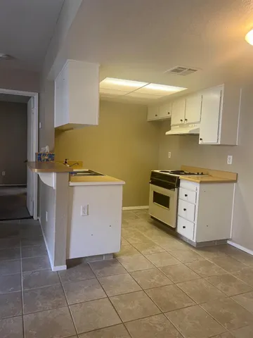 a view of utility room with cabinets