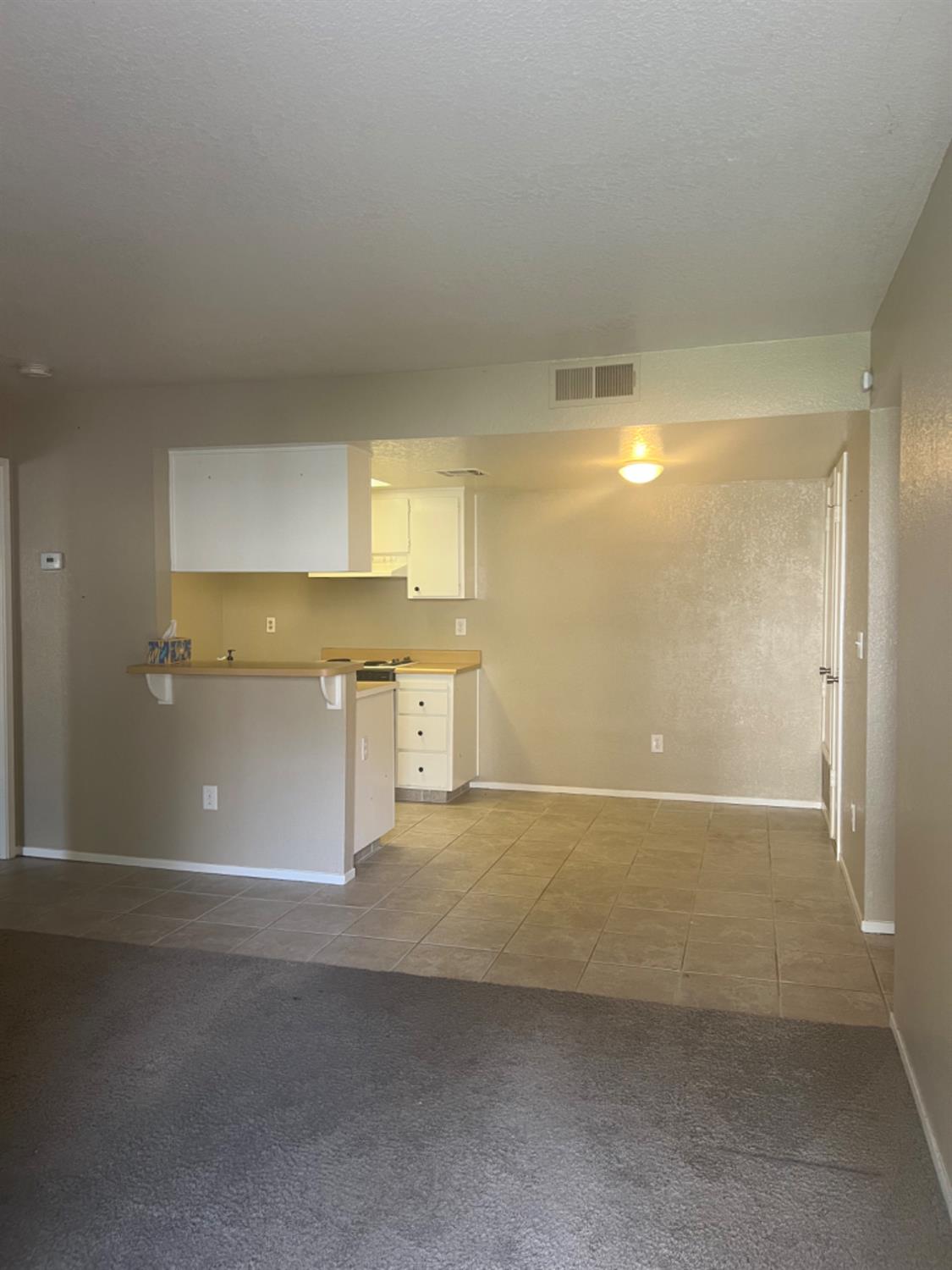 1545 Pyrenees Avenue, Unit 30 Stockton, CA 95210 - Photo 16 of 29 a view of a big room with wooden floor and windows