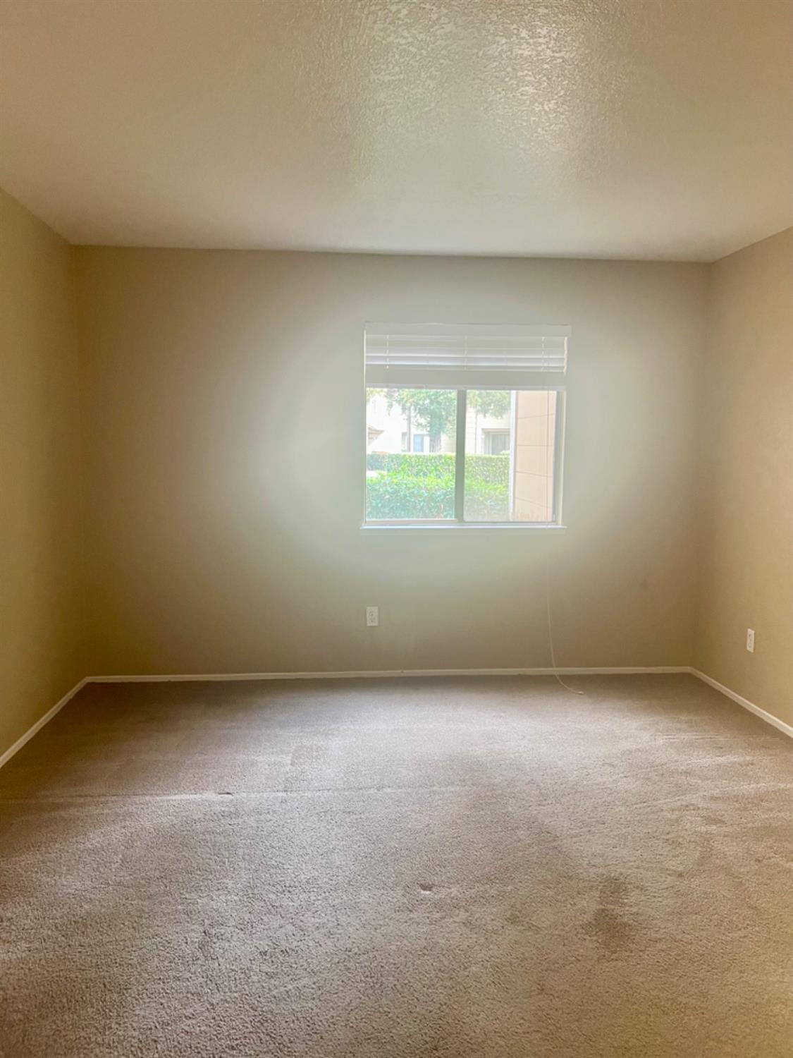 1545 Pyrenees Avenue, Unit 30 Stockton, CA 95210 - Photo 19 of 29 an empty room with a window