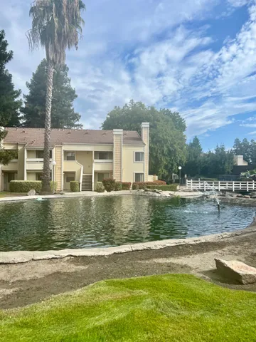 a view of a lake with a house in the background
