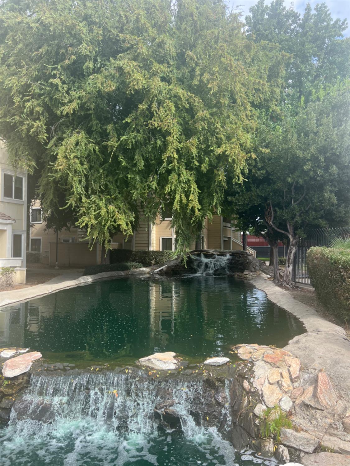 1545 Pyrenees Avenue, Unit 30 Stockton, CA 95210 - Photo 5 of 29 a view of a lake with a house in the background