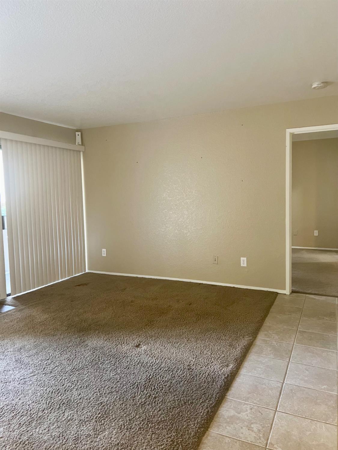 1545 Pyrenees Avenue, Unit 30 Stockton, CA 95210 - Photo 9 of 29 an empty room with a bench