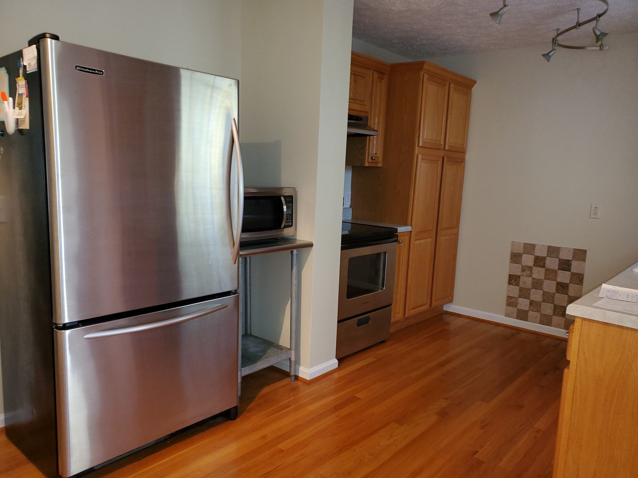 7583 Cherokee Hills Road Fairview, TN 37062 - Photo 45 of 62 a kitchen with stainless steel appliances granite countertop a refrigerator microwave and sink