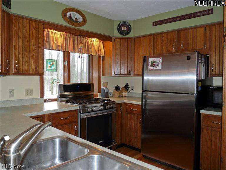 16532 Haskins Road Bainbridge, OH 44023 - Photo 3 of 19 WONDERFUL KITCHEN WITH STAINLESS STEEL APPLIANCES AND A PASS-THRU TO THE DINING ROOM.