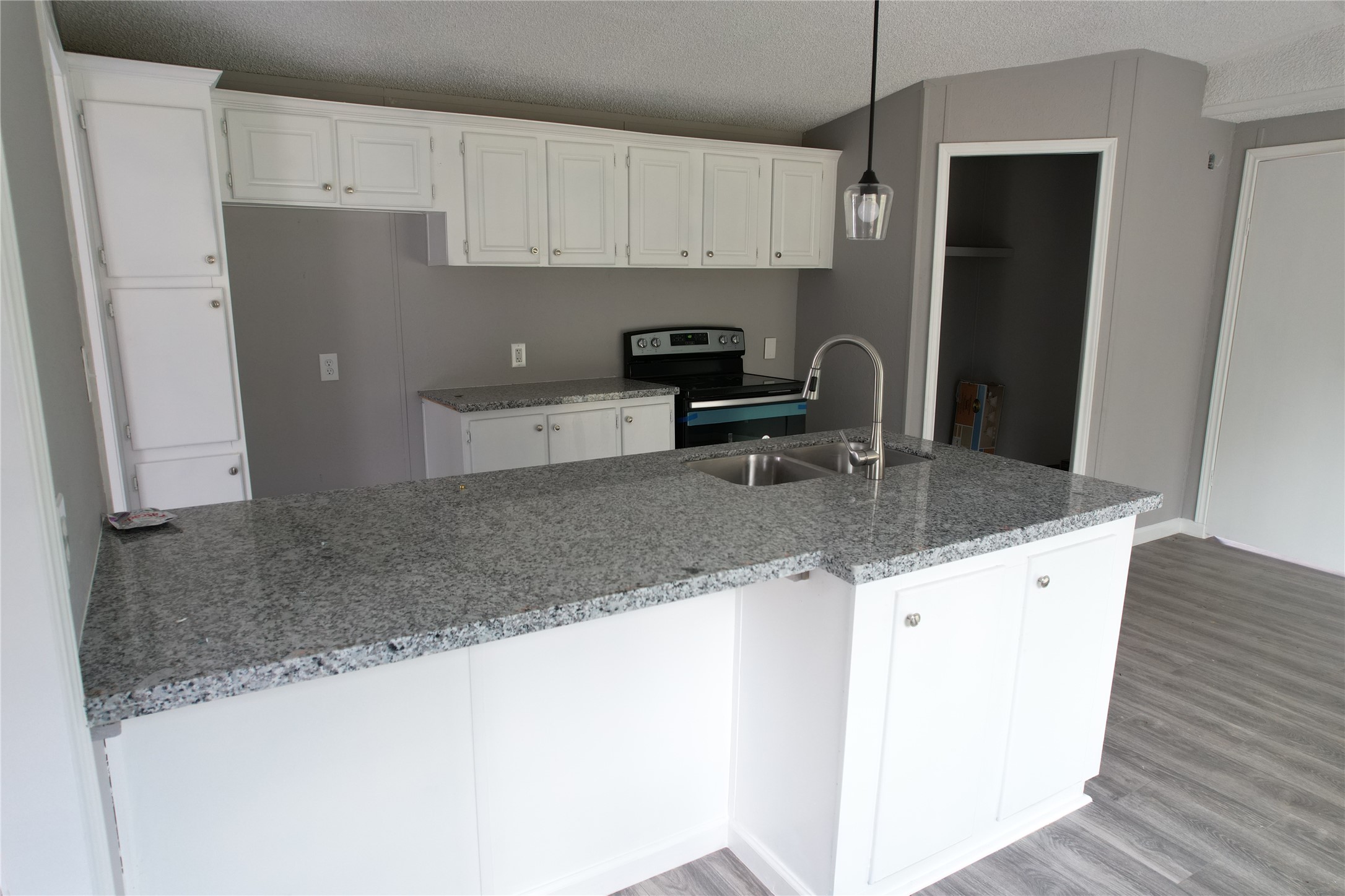 16428 Jireh Road Conroe, TX 77306 - Photo 11 of 25 a kitchen with granite countertop a sink a stove and refrigerator