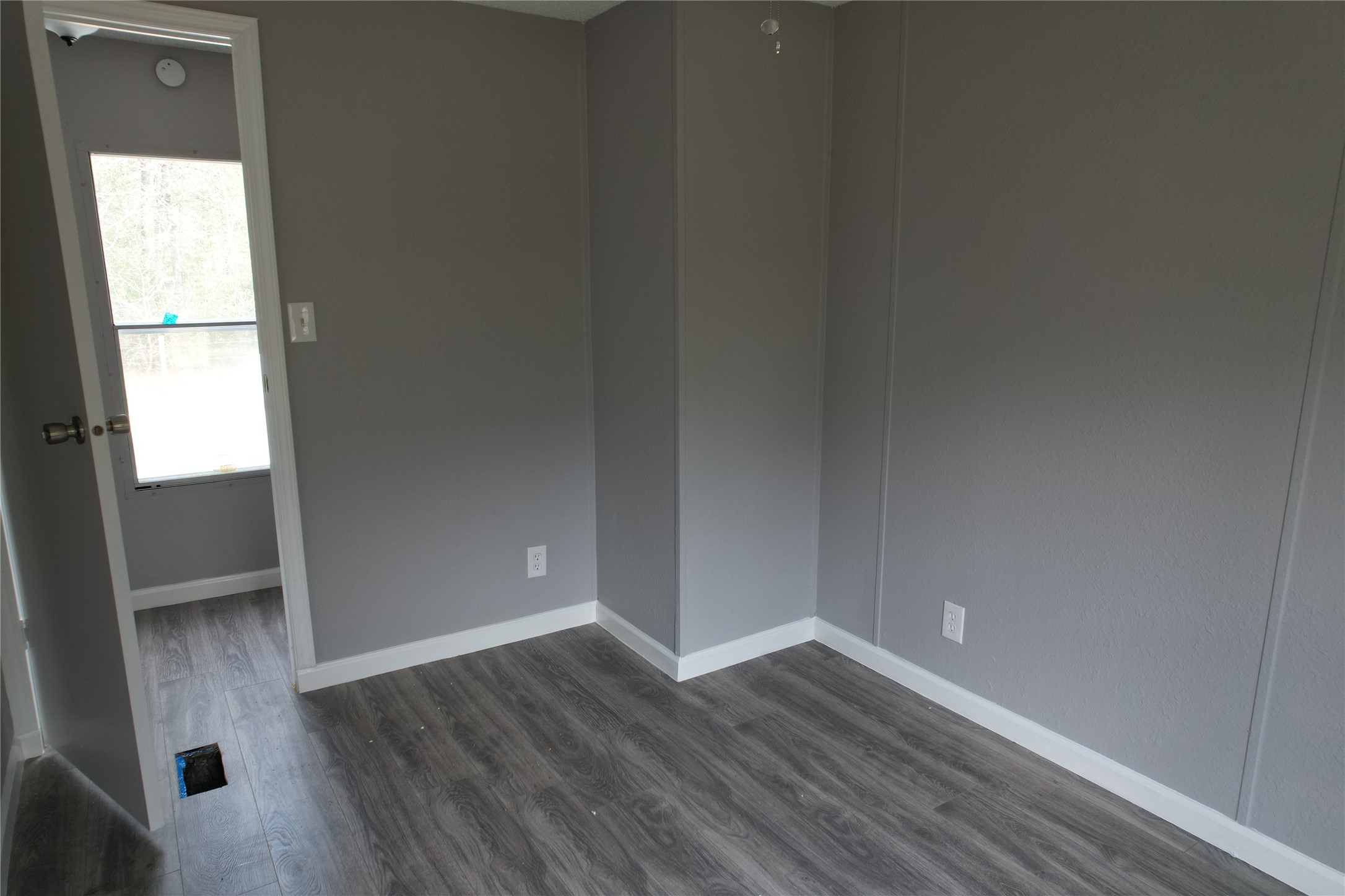 16428 Jireh Road Conroe, TX 77306 - Photo 15 of 25 a view of an empty room with wooden floor and a window