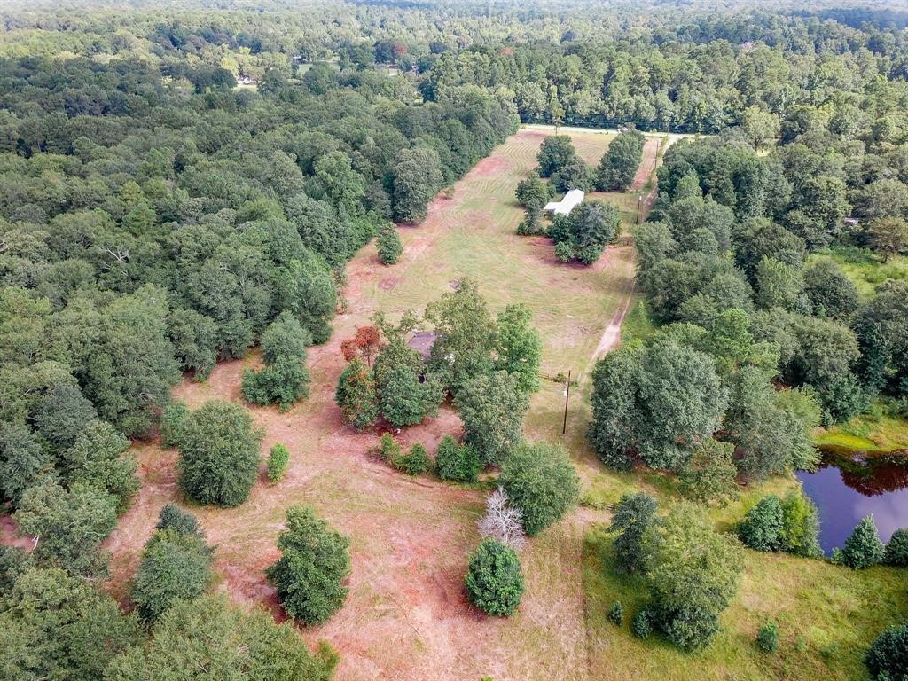 16428 Jireh Road Conroe, TX 77306 - Photo 25 of 25 an aerial view of a house with a yard and lake view