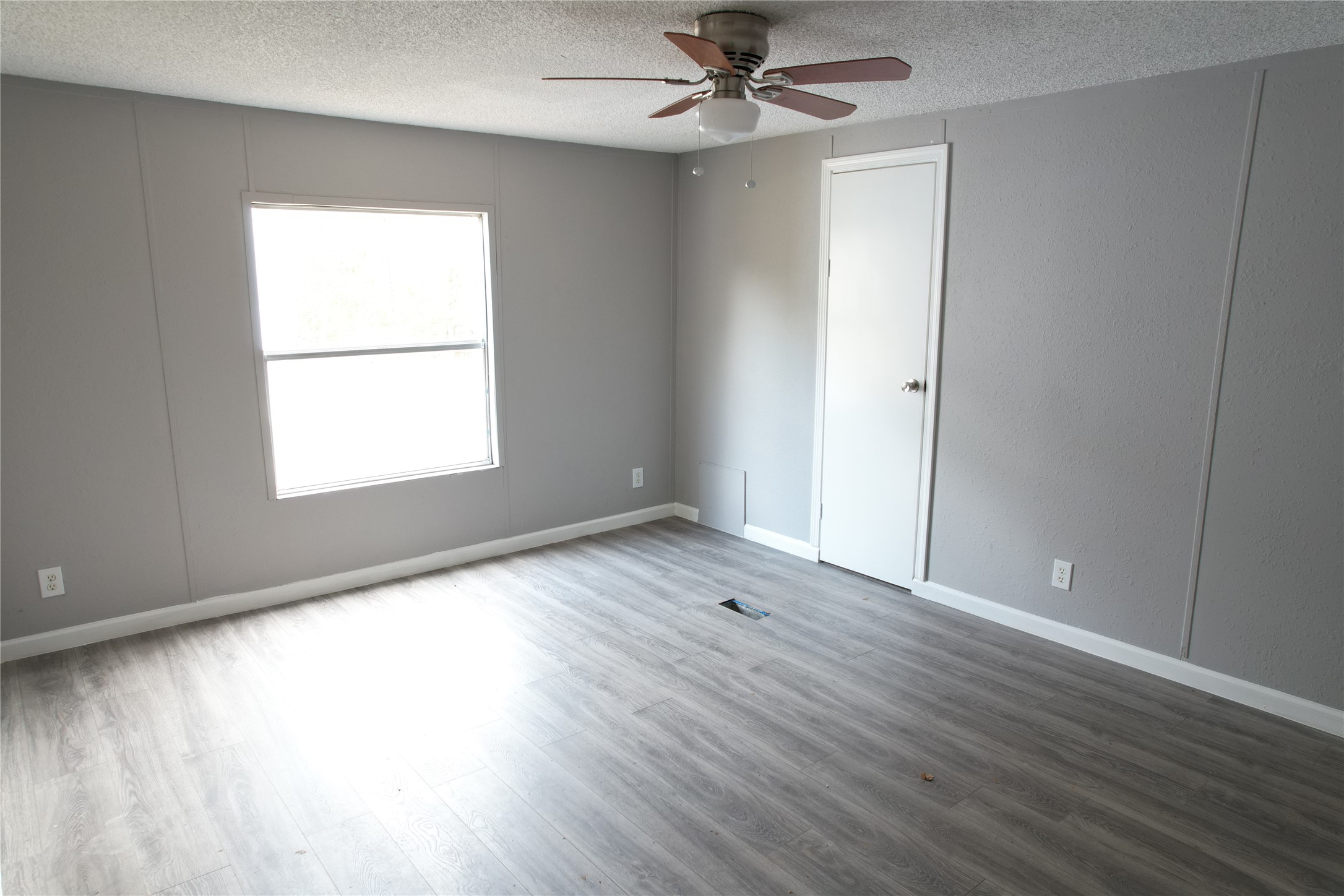16428 Jireh Road Conroe, TX 77306 - Photo 3 of 25 a view of an empty room with wooden floor and a window