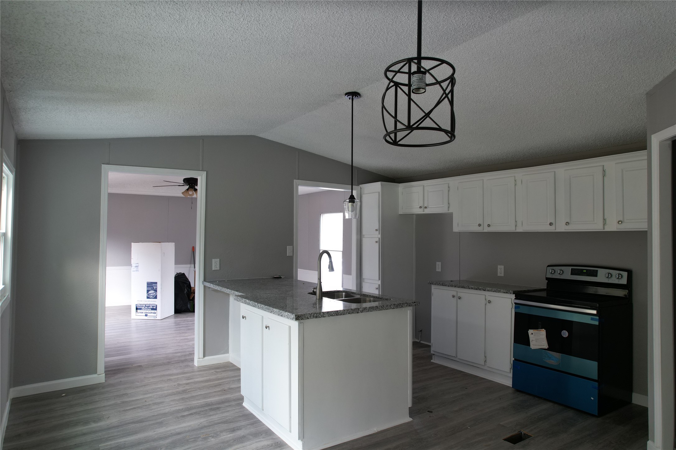 16428 Jireh Road Conroe, TX 77306 - Photo 8 of 25 a kitchen with kitchen island granite countertop stainless steel appliances a stove cabinets and wooden floor
