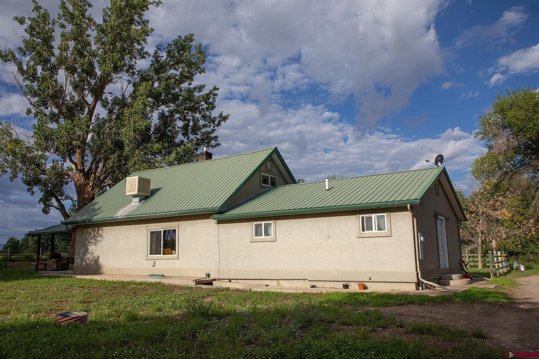 7531 High Mesa Road Olathe, CO 81425 - Photo 19 of 33 a front view of a house with a yard