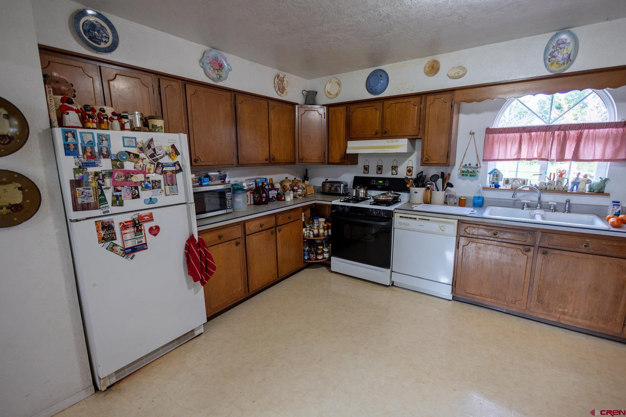 7531 High Mesa Road Olathe, CO 81425 - Photo 20 of 33 a kitchen with stainless steel appliances granite countertop a stove sink and cabinets