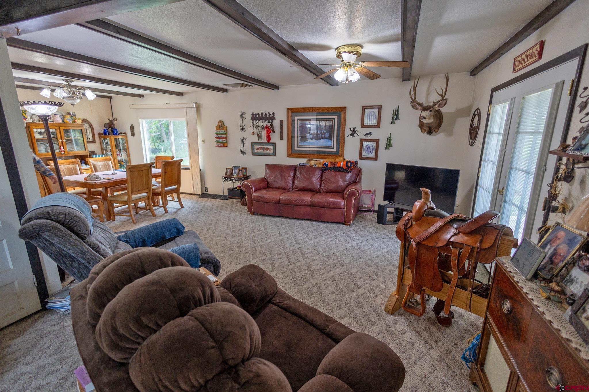 7531 High Mesa Road Olathe, CO 81425 - Photo 21 of 33 a living room with furniture and a flat screen tv