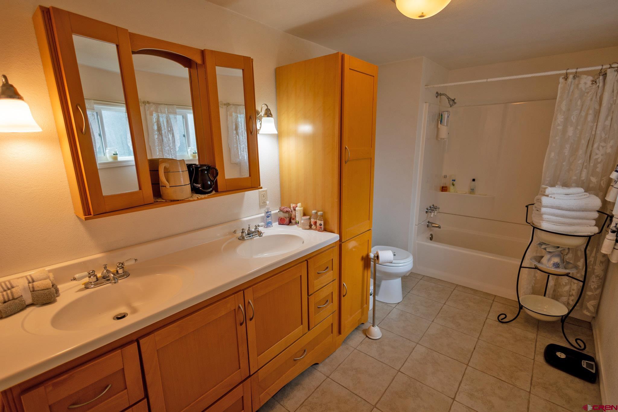 7531 High Mesa Road Olathe, CO 81425 - Photo 25 of 33 a spacious bathroom with a double vanity sink toilet mirror and shower