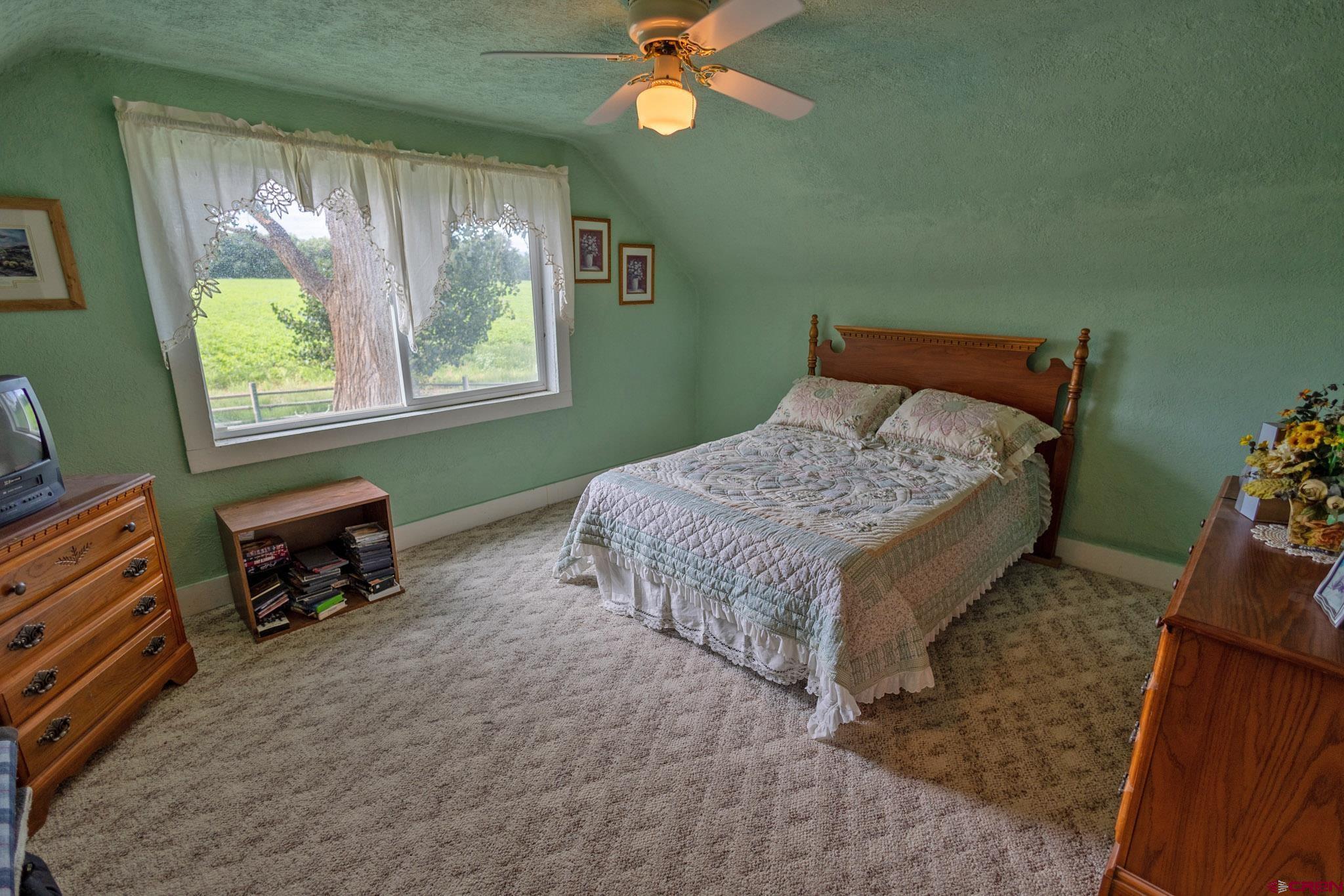 7531 High Mesa Road Olathe, CO 81425 - Photo 26 of 33 a bed sitting in a room next to a window