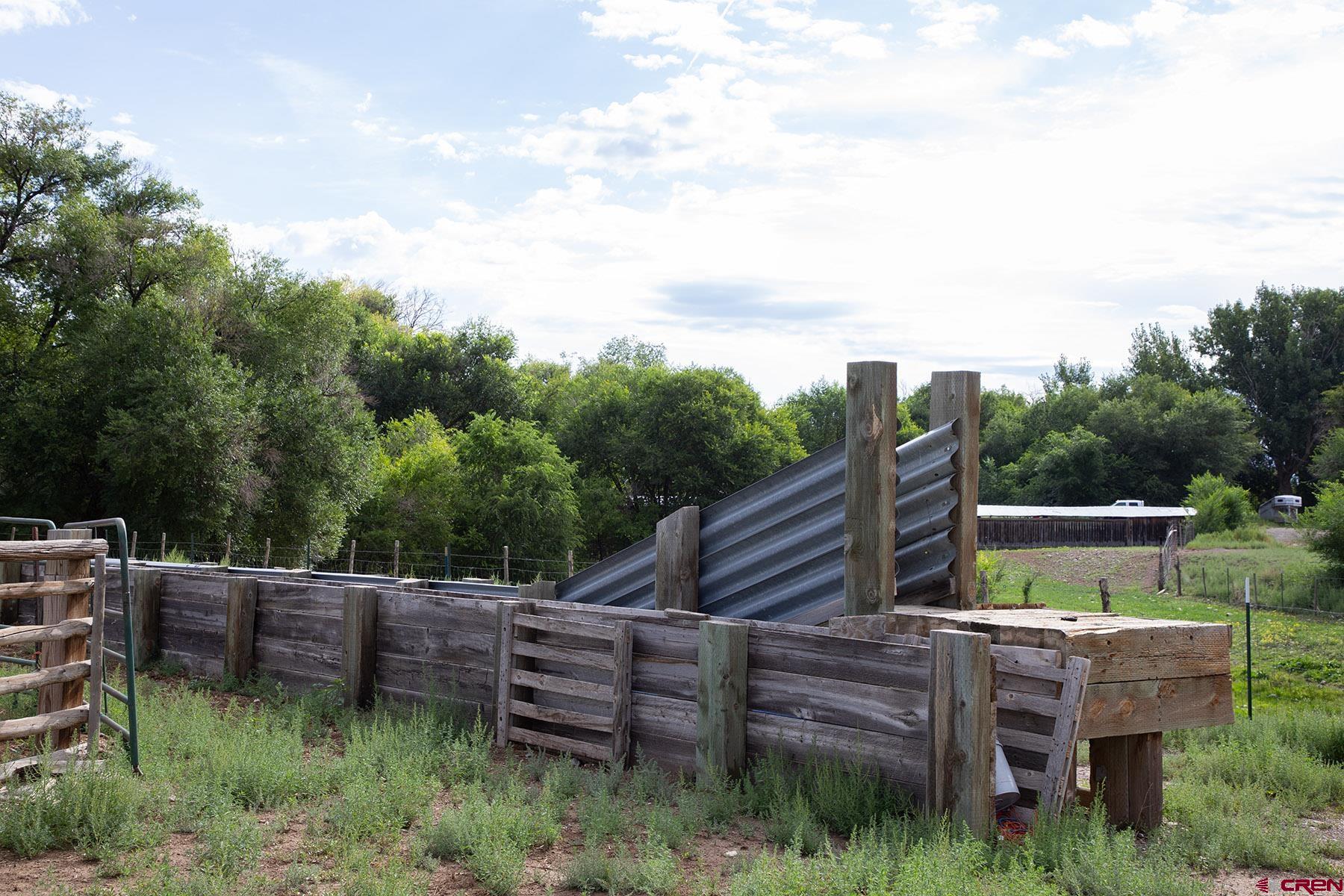 7531 High Mesa Road Olathe, CO 81425 - Photo 29 of 33 a backyard of a house with wooden floor and outdoor seating