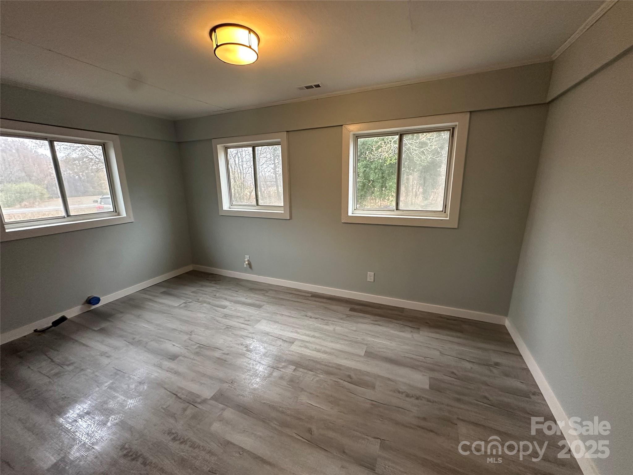 3401 Rilla Hamilton Road Monroe, NC 28110 - Photo 13 of 13 an empty room with wooden floor and windows