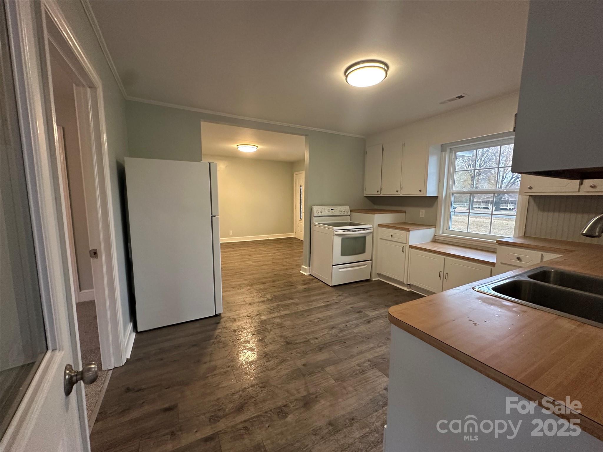 3401 Rilla Hamilton Road Monroe, NC 28110 - Photo 4 of 13 a kitchen with granite countertop a refrigerator stove and sink