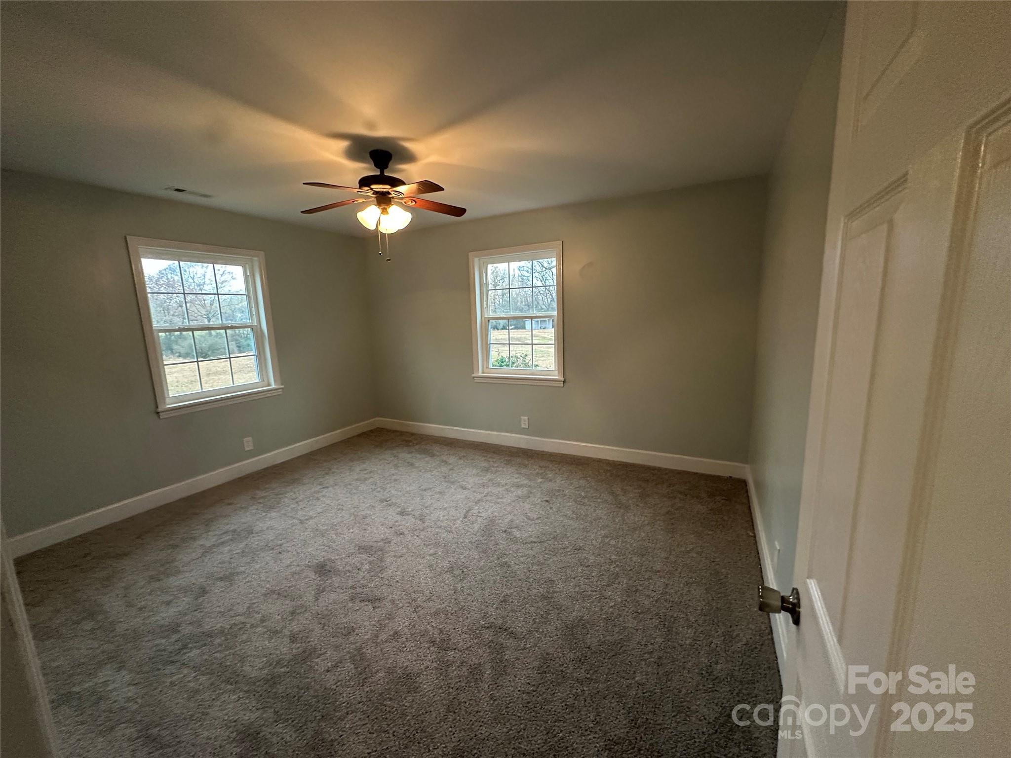 3401 Rilla Hamilton Road Monroe, NC 28110 - Photo 10 of 13 an empty room with windows and fan