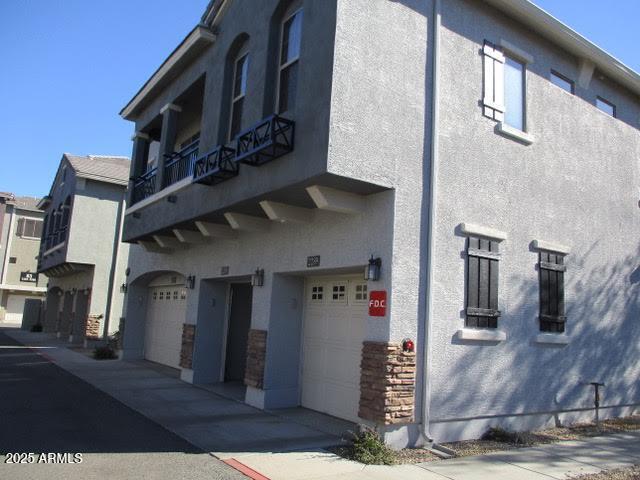 2150 West Alameda Road, Unit 1290 Phoenix, AZ 85085 - Photo 1 of 9 a front view of a house with garage