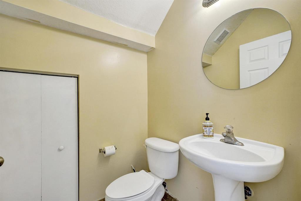 3303 Merrick Lane, Unit 1002 Margate, FL 33063 - Photo 13 of 33 a bathroom with a sink and a mirror