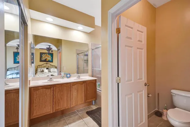 a bathroom with a double vanity sink mirror and shower