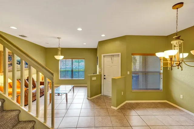 a kitchen with stainless steel appliances granite countertop a sink and a refrigerator