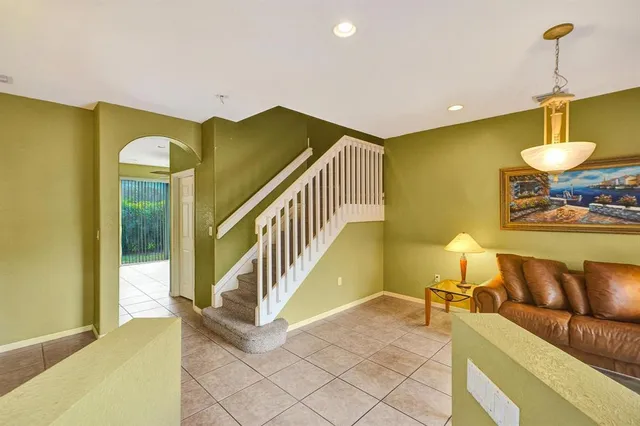 a view of a livingroom with furniture and stairs