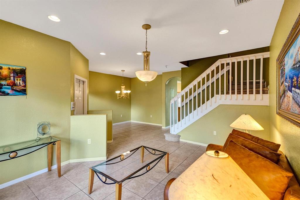 3303 Merrick Lane, Unit 1002 Margate, FL 33063 - Photo 6 of 33 a view of a livingroom with furniture a dinning room and windows