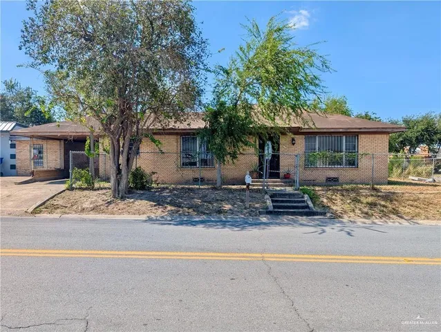 a front view of a house with a yard and a garage