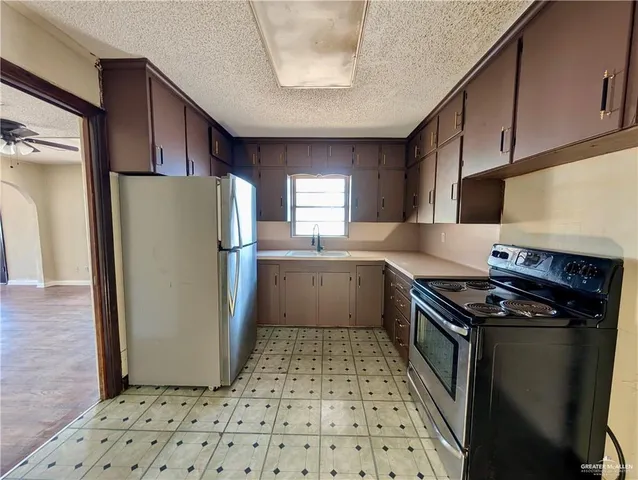 a kitchen with a refrigerator a sink and a stove
