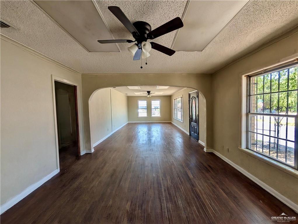 1015 Fresno Avenue McAllen, TX 78501 - Photo 5 of 14 wooden floor in an empty room with a window