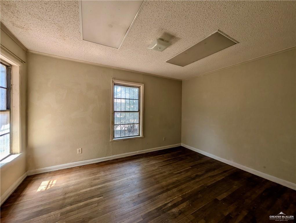 1015 Fresno Avenue McAllen, TX 78501 - Photo 8 of 14 a view of an empty room with wooden floor and a window