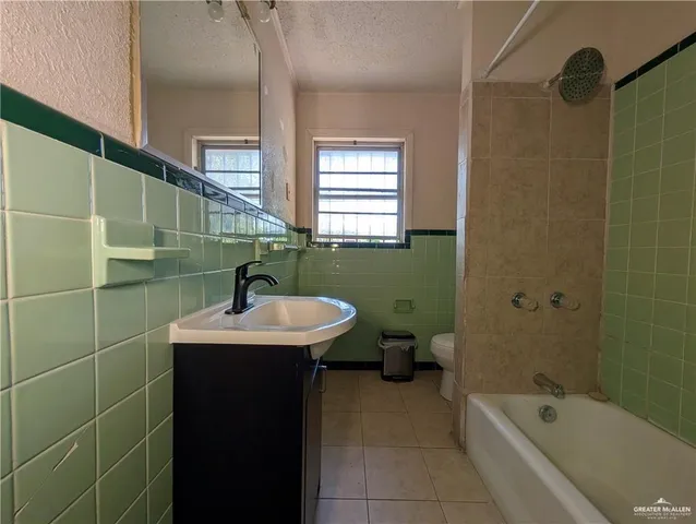 a bathroom with a sink a toilet and bathtub