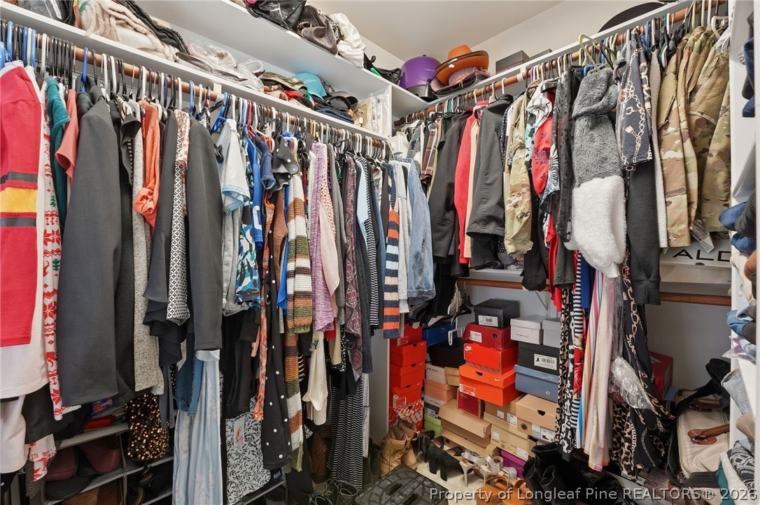 886 Micahs Way North Spring Lake, NC 28390 - Photo 24 of 50 a view of walk in closet with clothes