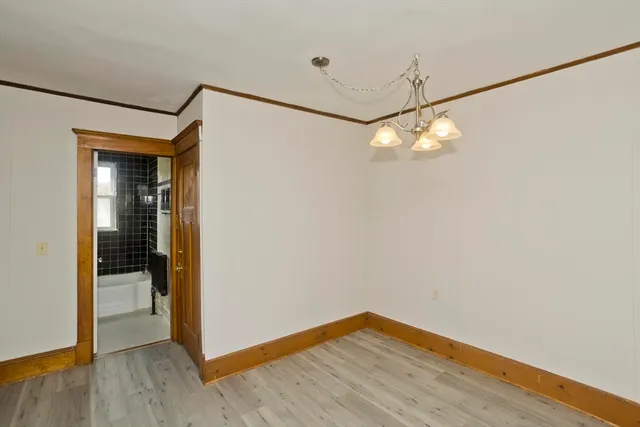 a view of a room with wooden floor