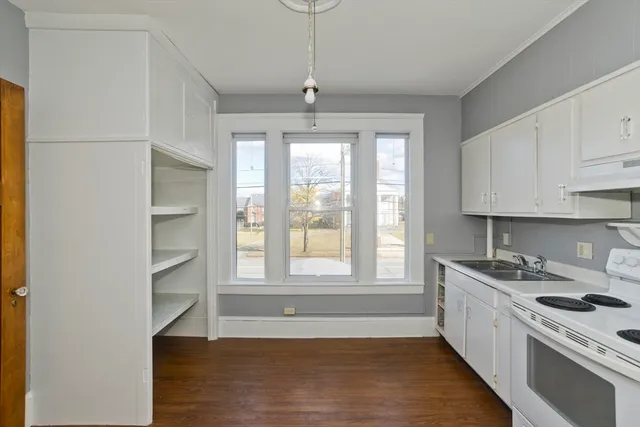 a kitchen that has a lot of windows in it
