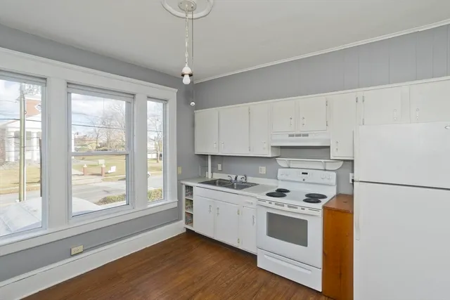 a kitchen with stainless steel appliances a stove a sink and a refrigerator