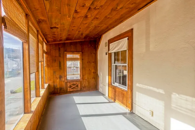 a view of hallway with a large window and pool table