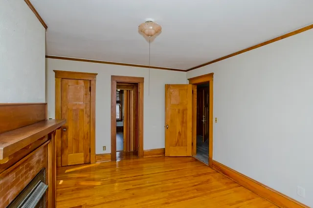 a view of an empty room with window and bathroom