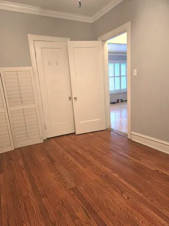 a view of an empty room and wooden floor