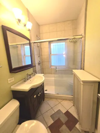 a bathroom with a double vanity sink toilet and mirror