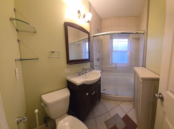 a bathroom with a toilet sink and mirror