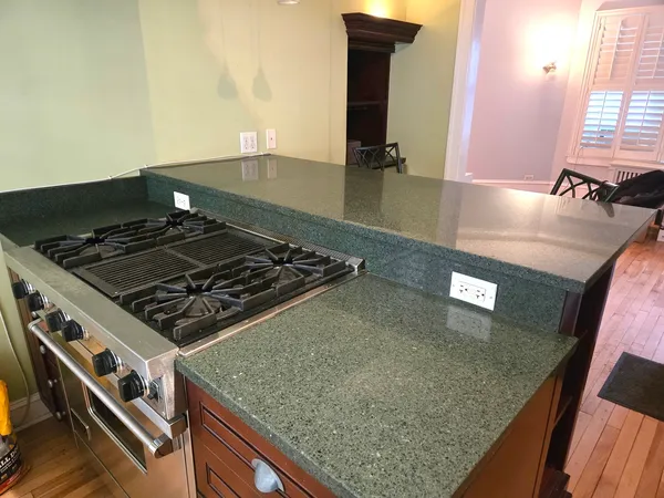 a kitchen with granite countertop a stove and a sink