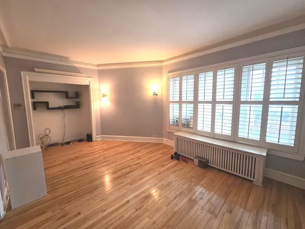 a big room with wooden floor and windows