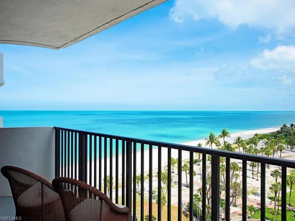a view of balcony with furniture and lake view