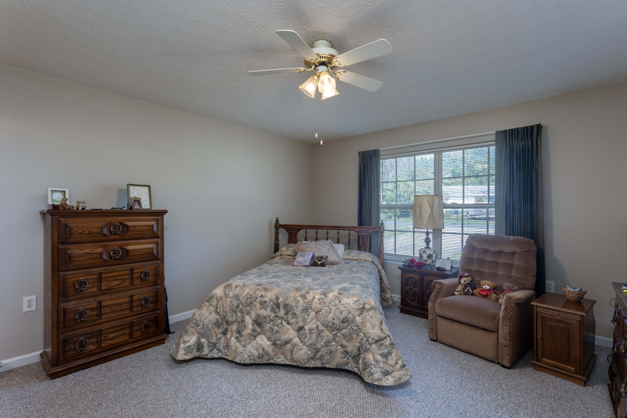 201 Broyles Road Spring City, TN 37381 - Photo 14 of 34 a bedroom with a bed and a chandelier