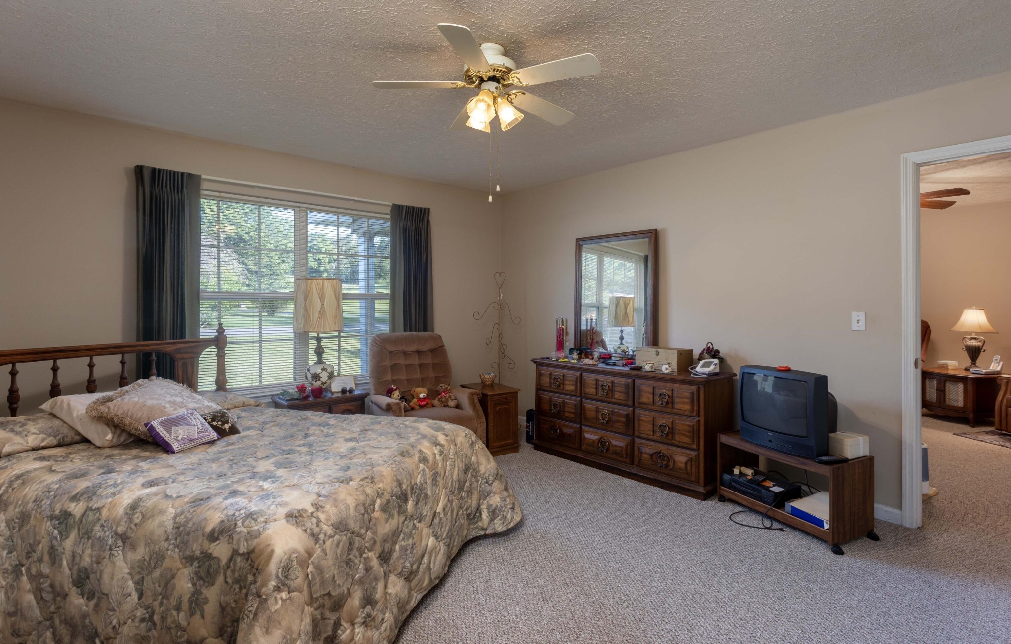 201 Broyles Road Spring City, TN 37381 - Photo 16 of 34 a bedroom with a bed and a chandelier fan