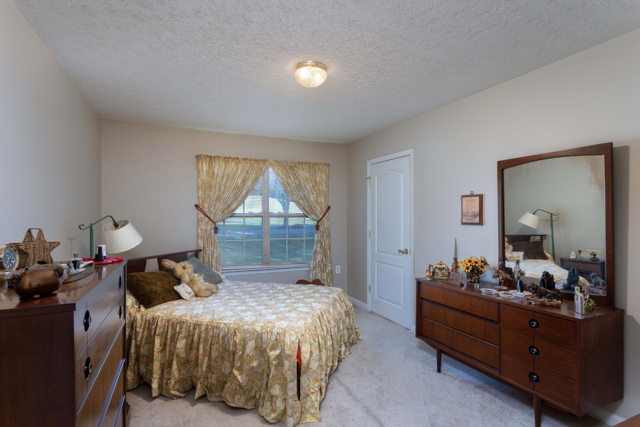 201 Broyles Road Spring City, TN 37381 - Photo 21 of 34 a bedroom with a bed and a mirror on dresser